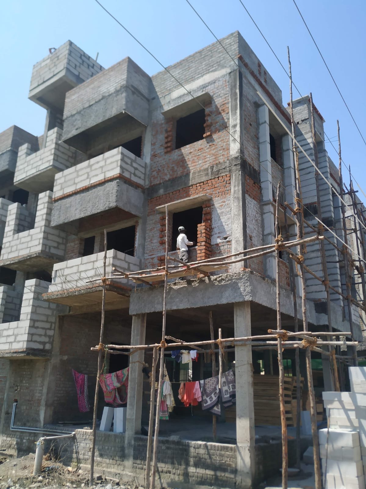 Multi-storey residential building construction with brick masonry and concrete framework
